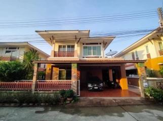 Two-story residential home with carport and balcony