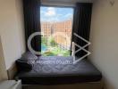 Cozy bedroom with large window overlooking the courtyard