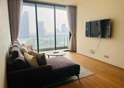 Spacious living room with large windows and city view