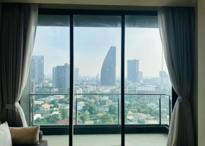 Bright bedroom with large windows and a cityscape view