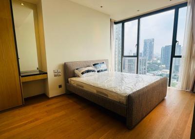 Modern bedroom with large window and city view