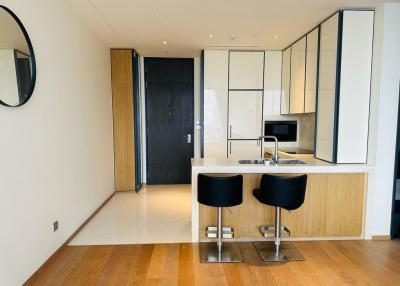 Modern kitchen with bar-style seating and integrated appliances