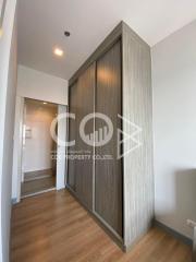 Modern bedroom with hardwood flooring and a large wardrobe