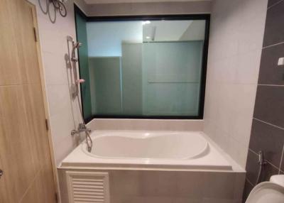 Modern bathroom with bathtub and frosted glass window