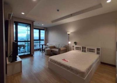 Spacious bedroom with modern furniture and ample natural light