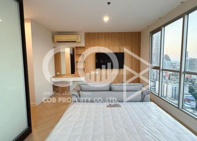 Spacious bedroom with modern design, large bed, and city view