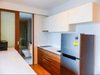 Modern kitchen with wooden cabinets and stainless steel appliances