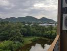 Scenic view from the balcony overlooking mountains and greenery