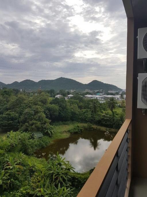 Scenic view from the balcony overlooking mountains and greenery