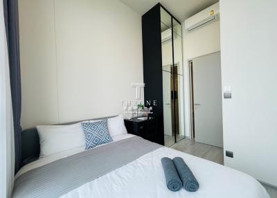 Modern bedroom with a large bed and mirrored wardrobe