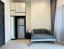 Modern living room with kitchenette and comfortable sofa
