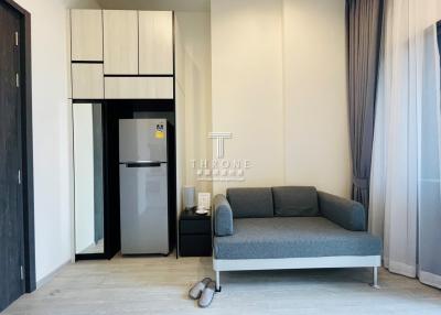 Modern living room with kitchenette and comfortable sofa
