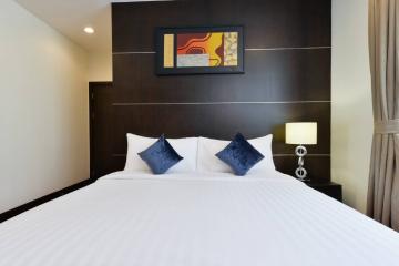 Modern bedroom with a large bed and artistic wall decor