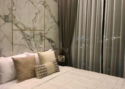 Elegant bedroom with marble wall and city view