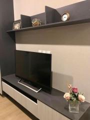 Modern living room with wall-mounted TV and decorative shelving