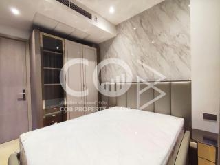 Modern bedroom with a large bed and marble wall