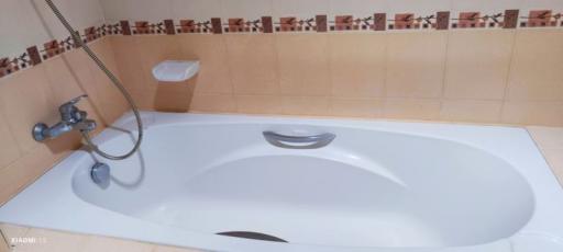 Modern bathroom with a clean bathtub and decorative tiles