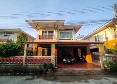 Two-story residential house with carport and balcony