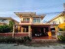 Two-story residential house with carport and balcony