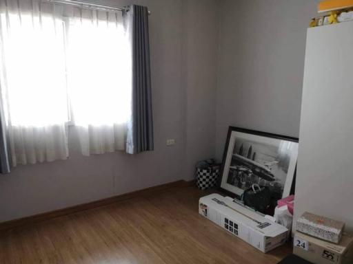 Unfurnished bedroom with hardwood floor and natural light