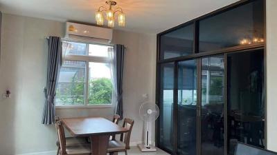 Cozy dining room with large window and glass doors