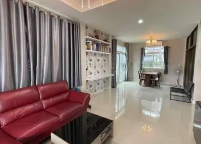 Spacious and modern living room with red sofa and glossy tiled flooring