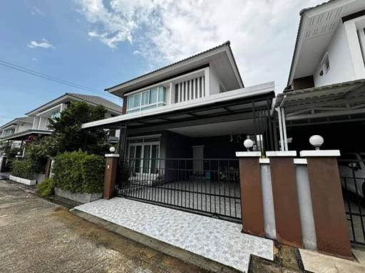 Modern two-story house with a carport and balcony