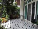 Spacious tiled patio with green plants and outdoor furniture