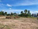 Spacious undeveloped land with scenic mountain backdrop under a clear blue sky