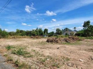 Spacious vacant land with a clear sky and mountain in the background