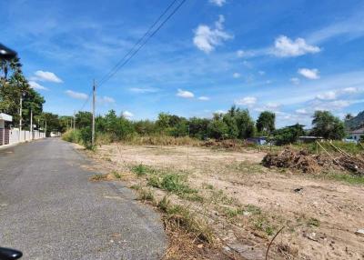 Empty residential plot of land under a blue sky