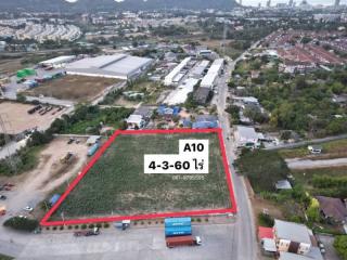 Aerial view of an empty plot of land marked for sale with surroundings