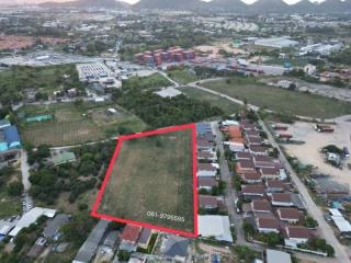 Aerial view of an open plot of land for sale within a developed area