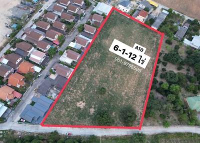Aerial view of a vacant land plot for sale surrounded by residential buildings