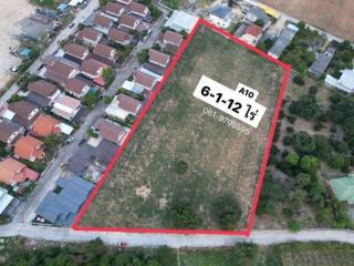 Aerial view of a vacant land plot for sale surrounded by residential buildings