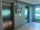 Modern building lobby with elevator access and digital directory