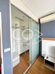 Compact bedroom with built-in wardrobe and air conditioning unit