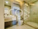 Modern bathroom interior with a glass shower and well-lit vanity area