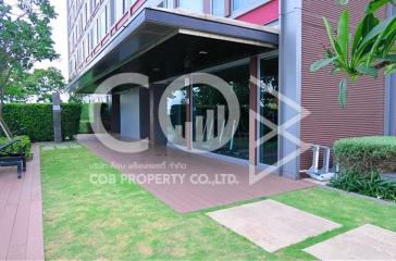 Modern residential building entrance with landscaped garden