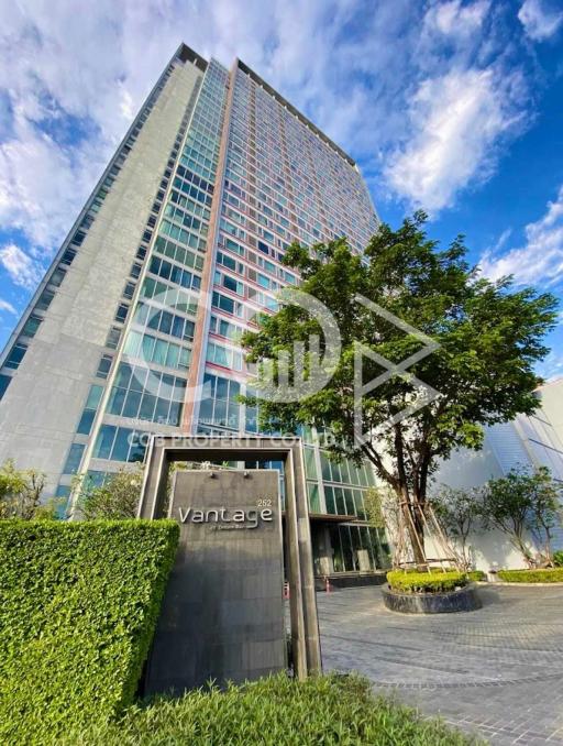 Modern high-rise residential building with clear blue sky