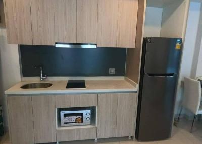 Modern kitchen with wooden cabinets and black countertops