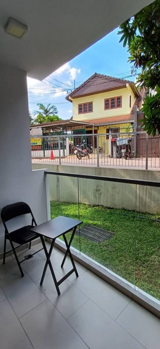 Cozy covered patio area with a view of a residential neighborhood