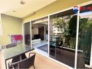 Spacious balcony with outdoor furniture and indoor view