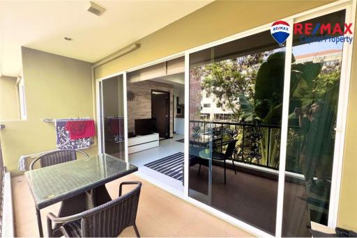 Spacious balcony with outdoor furniture and indoor view