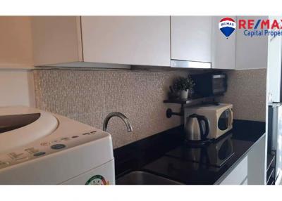 Modern kitchen with stainless steel appliances and mosaic backsplash