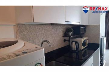 Modern kitchen with stainless steel appliances and mosaic backsplash