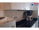 Modern kitchen with stainless steel appliances and mosaic backsplash