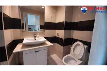 Modern bathroom with black and white tiled walls