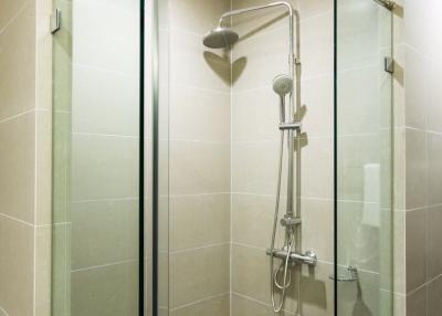 Modern bathroom with glass shower enclosure and tiled walls