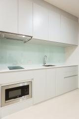 Modern white kitchen with built-in appliances